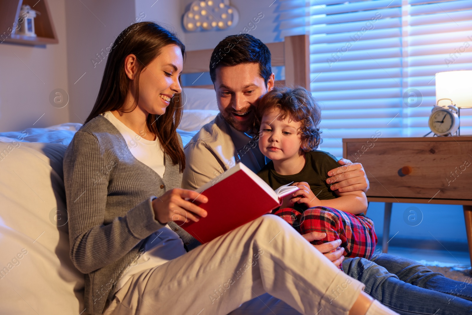 Happy family reading bedtime story at home Photo of Happy family reading bedtime story at home