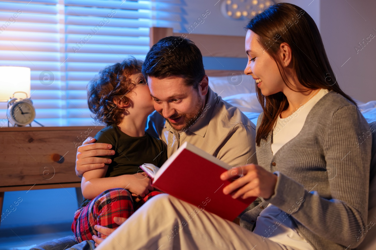 Happy family reading bedtime story at home Photo of Happy family reading bedtime story at home