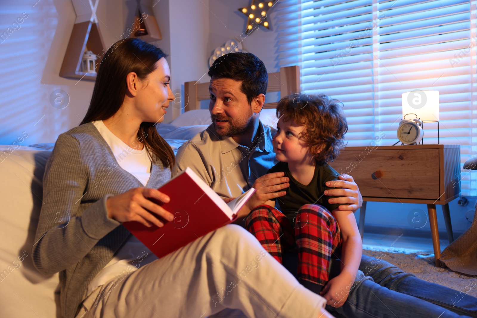 Happy family reading bedtime story at home Photo of Happy family reading bedtime story at home
