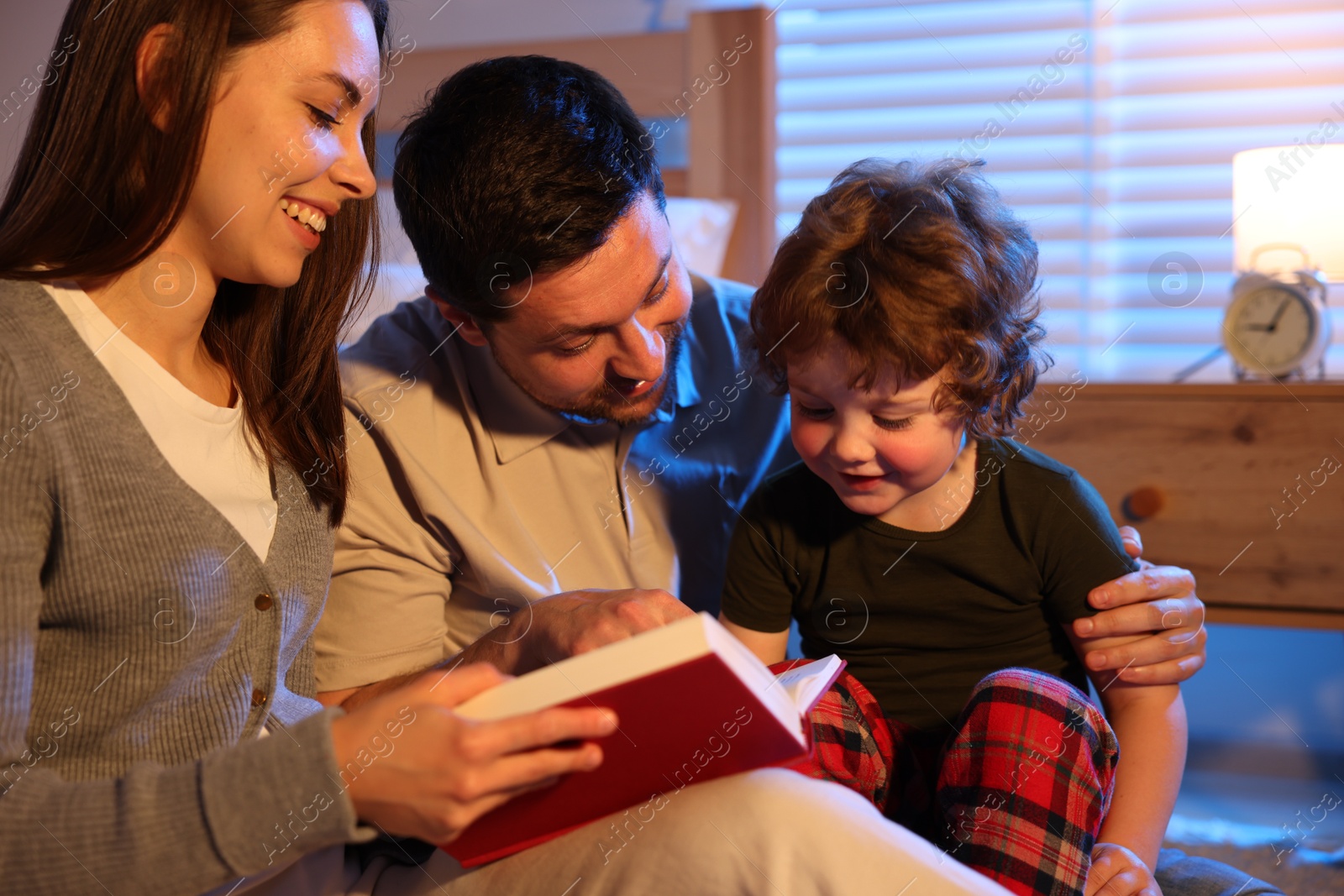 Happy family reading bedtime story at home Photo of Happy family reading bedtime story at home