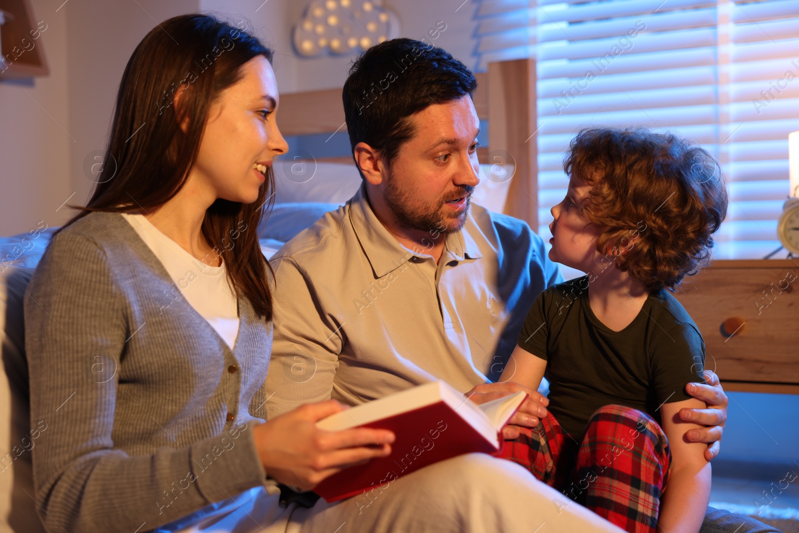 Happy family reading bedtime story at home Photo of Happy family reading bedtime story at home