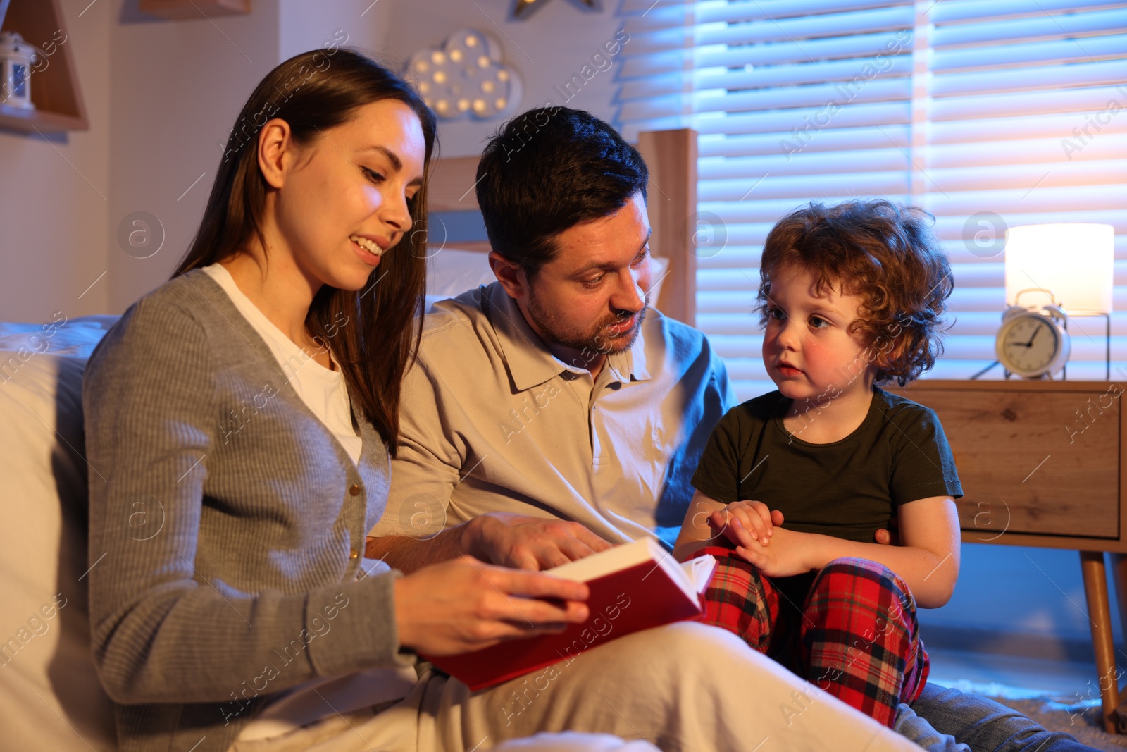 Happy family reading bedtime story at home Photo of Happy family reading bedtime story at home