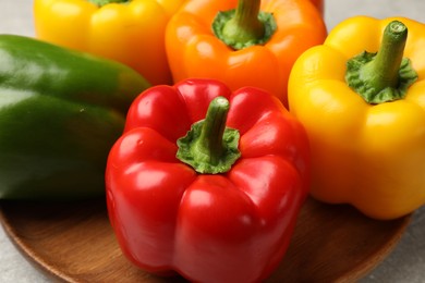 Photo of Fresh colorful bell peppers on table, closeup