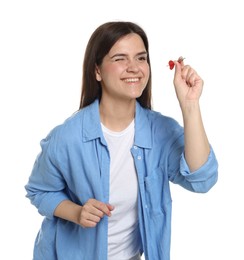 Photo of Targeting. Smiling woman with dart aiming on white background