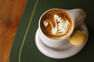 Photo of Aromatic coffee in cup and cookie on table, above view. Space for text