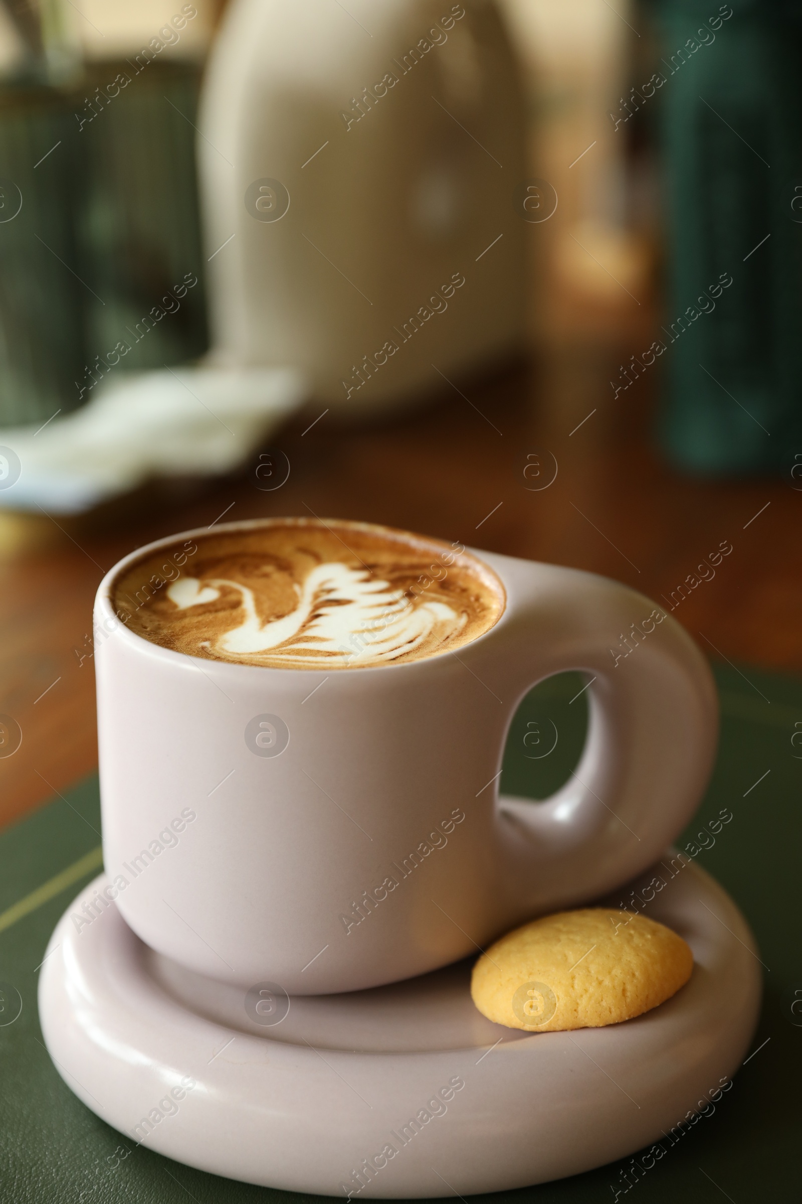 Aromatic coffee in cup and cookie on table, closeup Photo of Aromatic coffee in cup and cookie on table, closeup