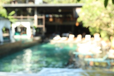 Photo of Blurred view of sunbeds and swimming pool outdoors