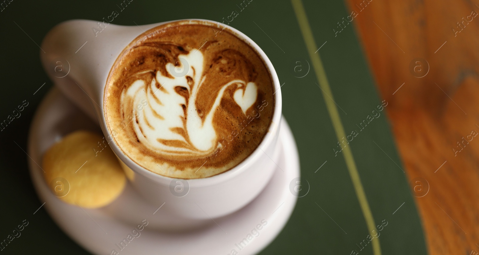 Aromatic coffee in cup and cookie on table, above view. Space for text Photo of Aromatic coffee in cup and cookie on table, above view. Space for text