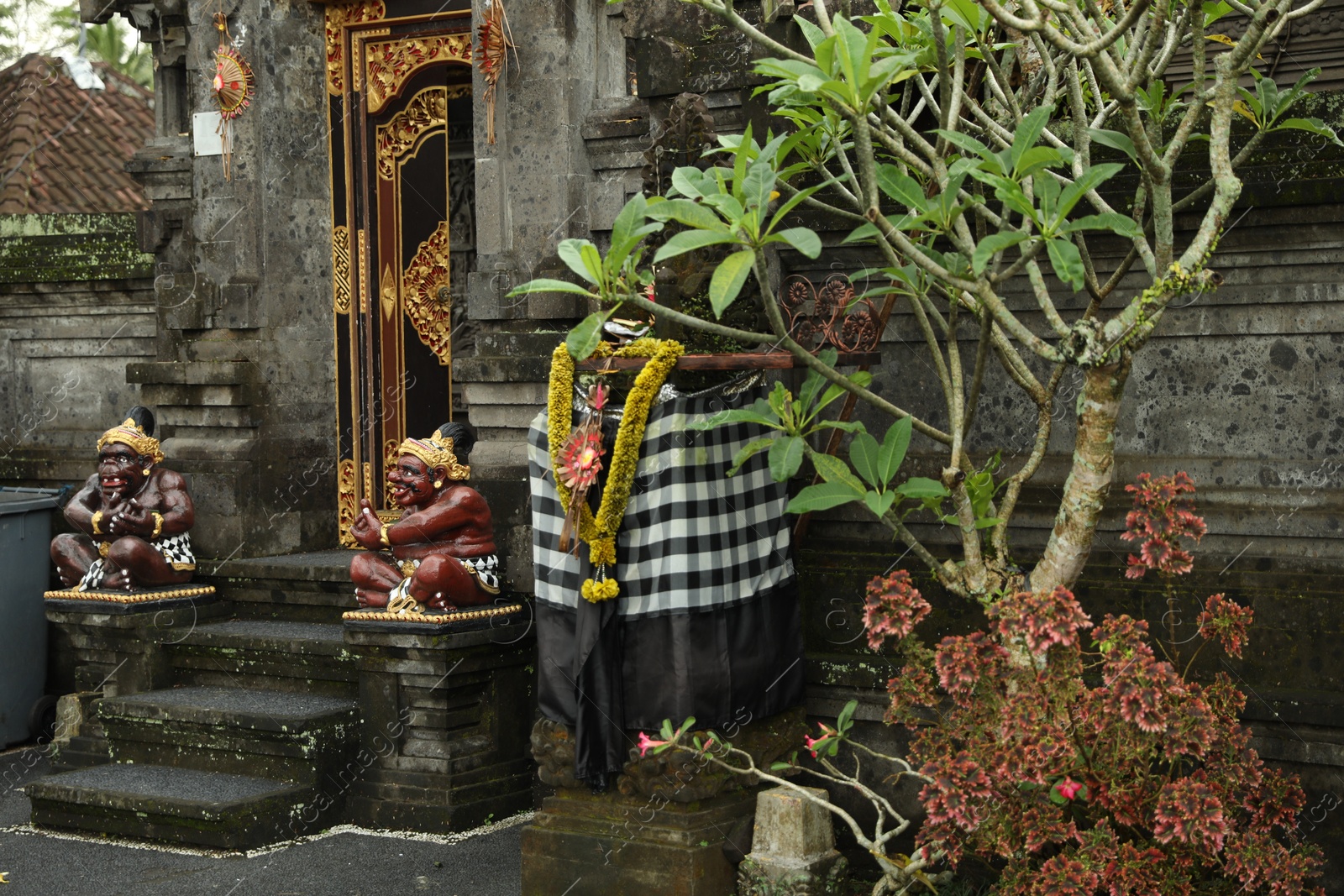 Bali, Indonesia - May 11, 2025: Entrance of Pura Dalem temple with beautiful statues and other decor outdoors Photo of Bali, Indonesia - May 11, 2025: Entrance of Pura Dalem temple with beautiful statues and other decor outdoors