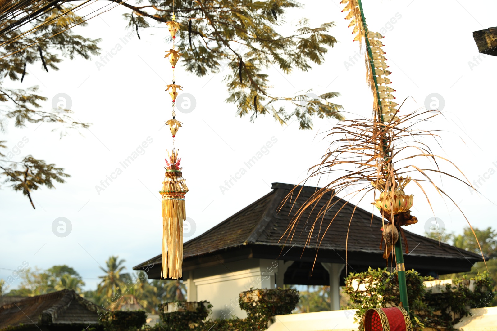 City street decorated with beautiful traditional penjor Photo of City street decorated with beautiful traditional penjor