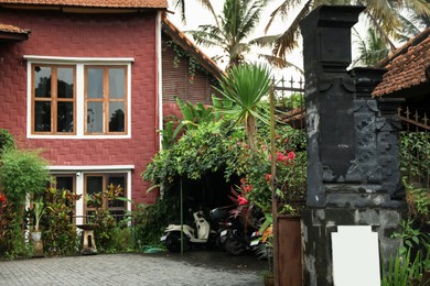 Photo of Beautiful building, different plants and scooters outdoors