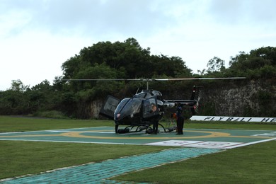Photo of Indonesia, Bali - May 13, 2025: Helicopter crew preparing for takeoff at heliport