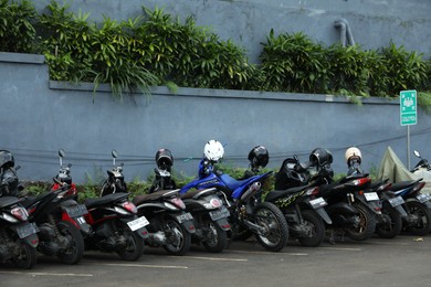 Photo of Indonesia, Bali - May 13, 2025: Many different motorcycles parked outdoors