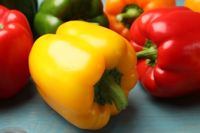 Photo of Fresh colorful bell peppers on blue wooden table, closeup