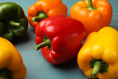 Photo of Fresh colorful bell peppers on blue wooden table, closeup