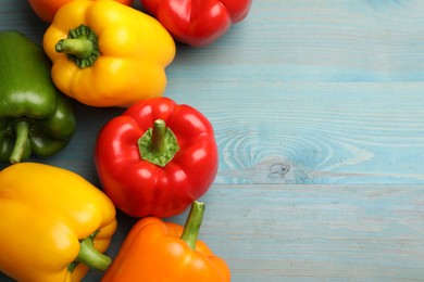 Photo of Fresh colorful bell peppers on blue wooden table, flat lay. Space for text