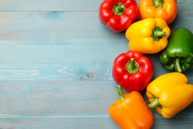 Photo of Fresh colorful bell peppers on blue wooden table, flat lay. Space for text