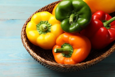 Photo of Fresh colorful bell peppers on blue wooden table, closeup