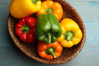 Photo of Fresh colorful bell peppers on blue wooden table, top view