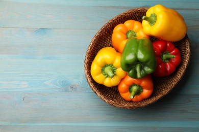 Photo of Fresh colorful bell peppers on blue wooden table, top view. Space for text