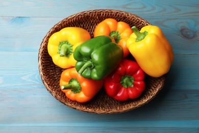 Photo of Fresh colorful bell peppers on blue wooden table, top view