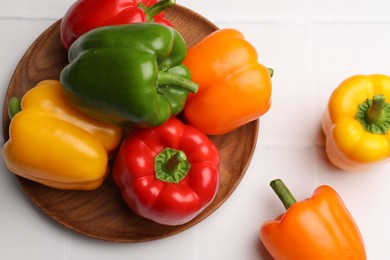 Photo of Fresh colorful bell peppers on white table, flat lay