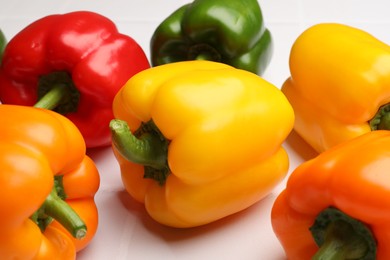 Photo of Fresh colorful bell peppers on light table, closeup