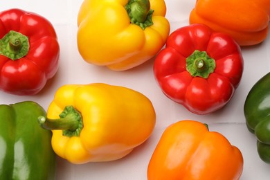 Photo of Fresh colorful bell peppers on white table, flat lay