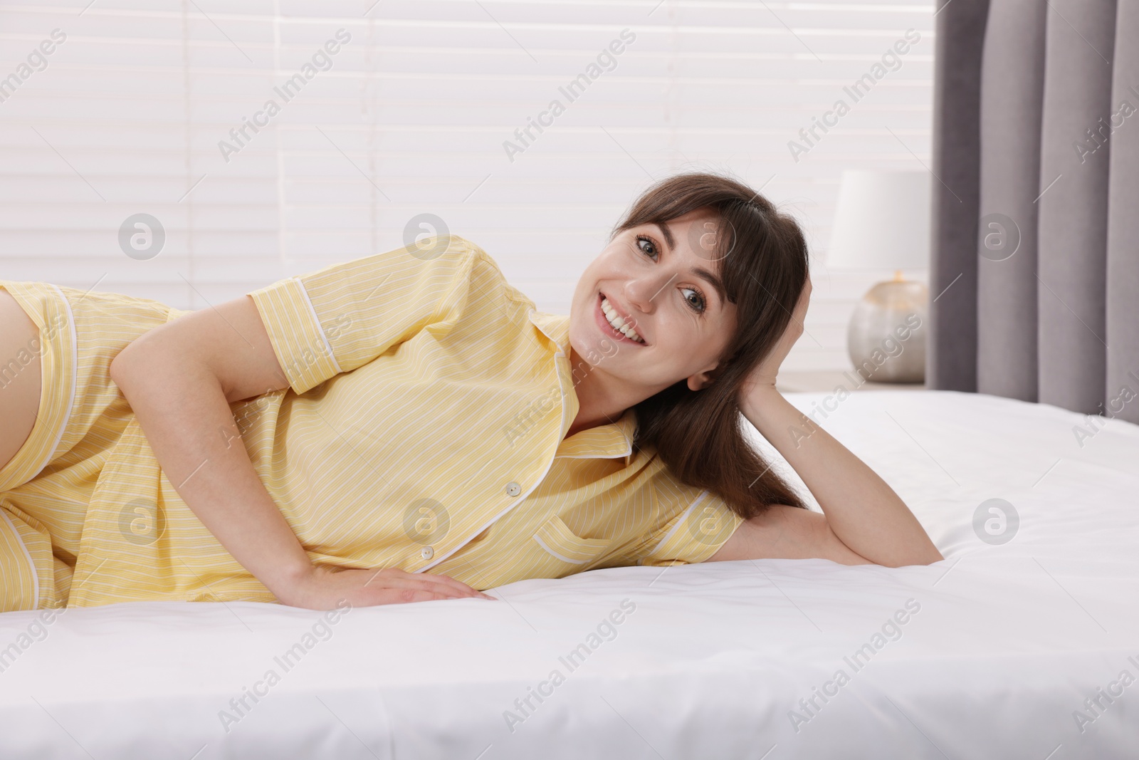 Beautiful woman lying on soft mattress at home Photo of Beautiful woman lying on soft mattress at home