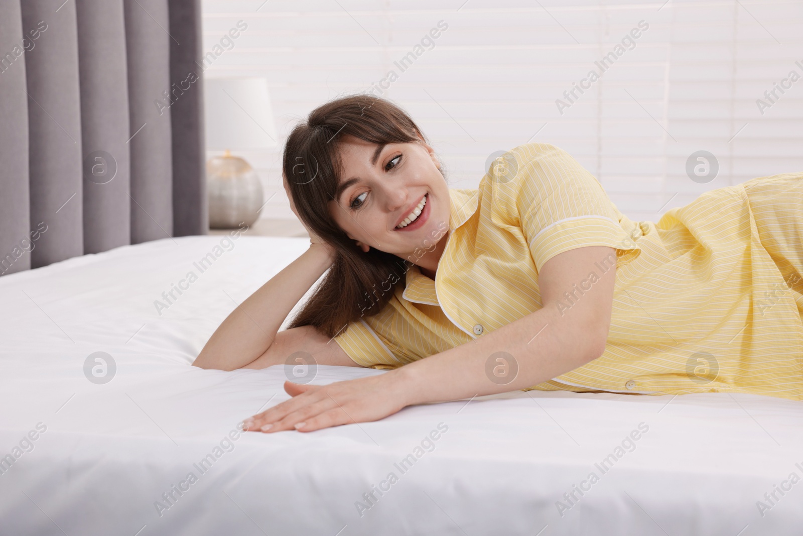 Beautiful woman lying on soft mattress at home Photo of Beautiful woman lying on soft mattress at home
