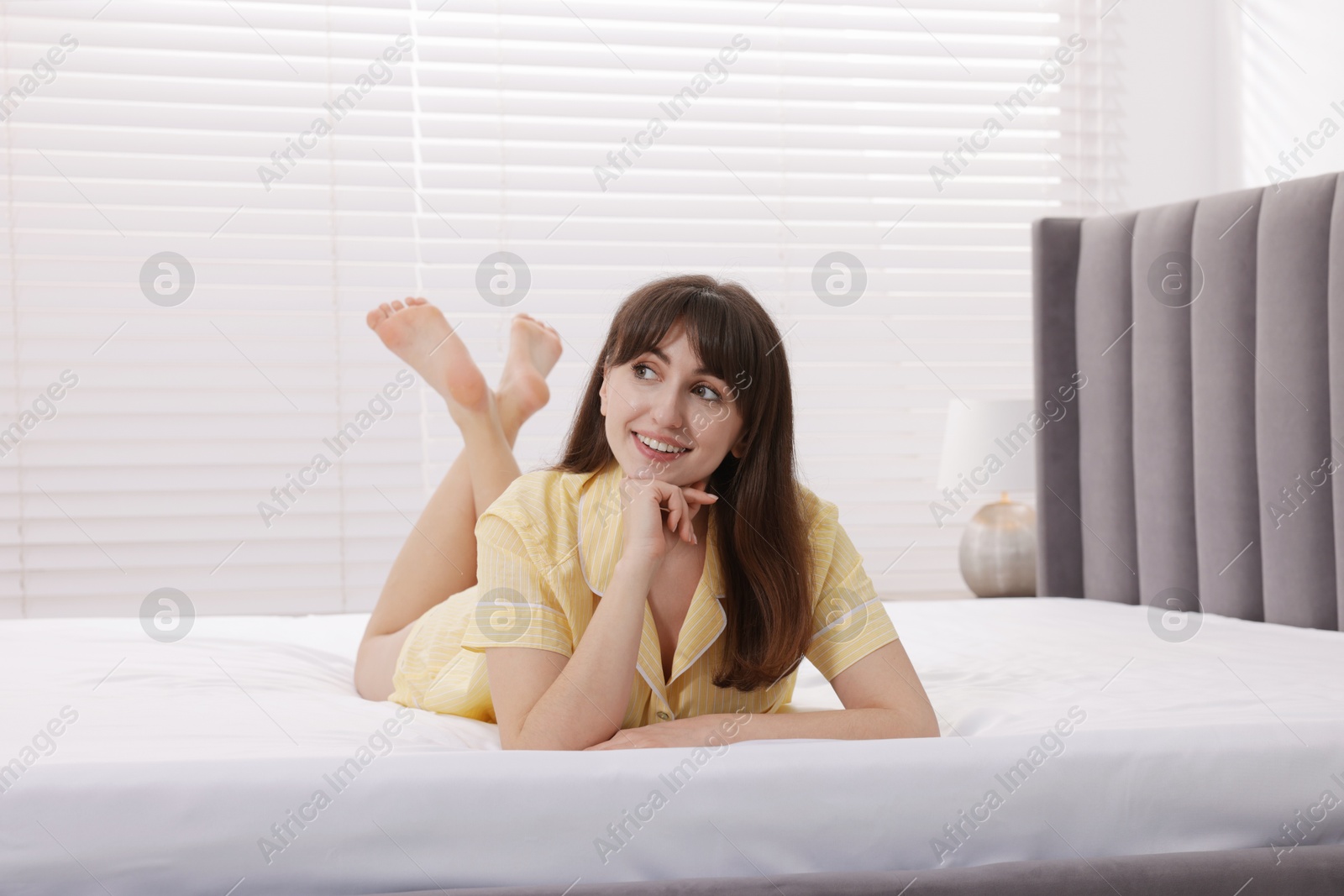 Beautiful woman lying on soft mattress at home Photo of Beautiful woman lying on soft mattress at home