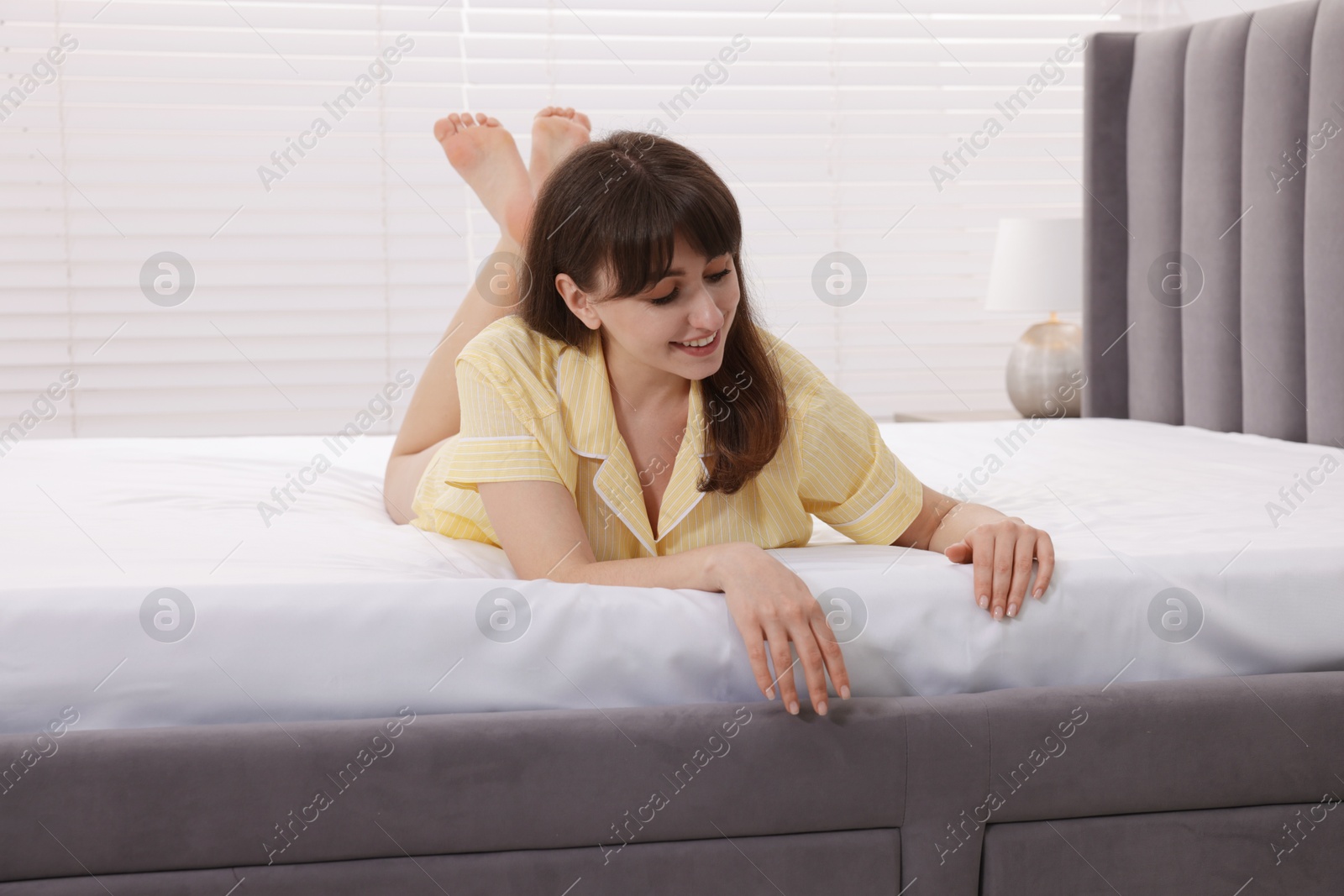 Beautiful woman lying on soft mattress at home Photo of Beautiful woman lying on soft mattress at home