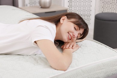Photo of Beautiful woman sleeping on soft mattress at home