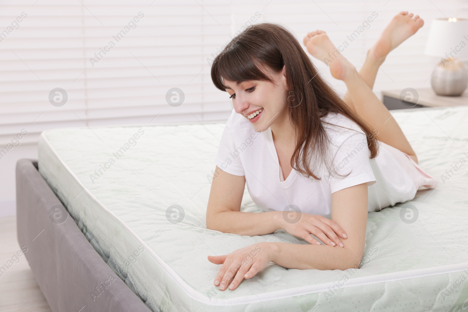 Beautiful woman lying on soft mattress at home Photo of Beautiful woman lying on soft mattress at home
