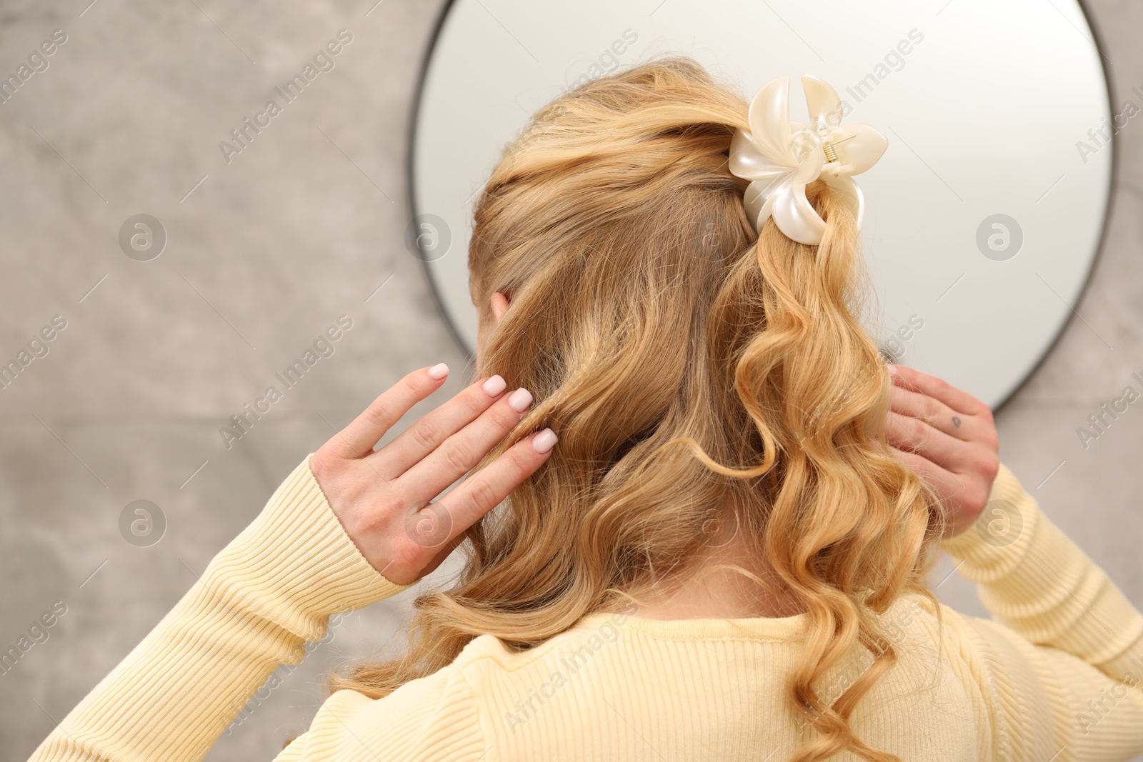 Woman with beautiful hair curls indoors, back view Photo of Woman with beautiful hair curls indoors, back view