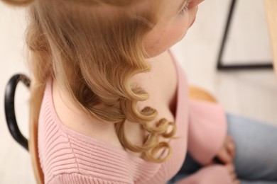 Photo of Woman with beautiful hair curls indoors, closeup