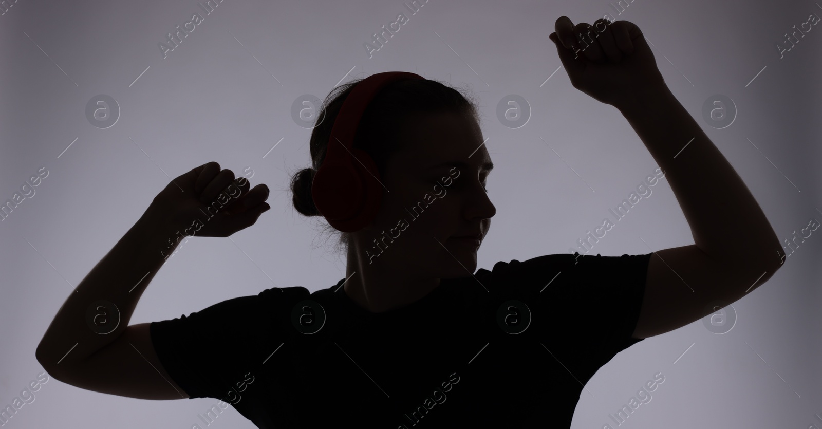 Silhouette of woman posing on grey background Photo of Silhouette of woman posing on grey background