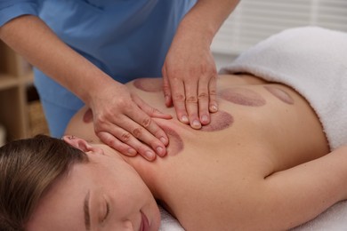 Photo of Cupping therapy. Woman receiving professional massage in spa salon, closeup