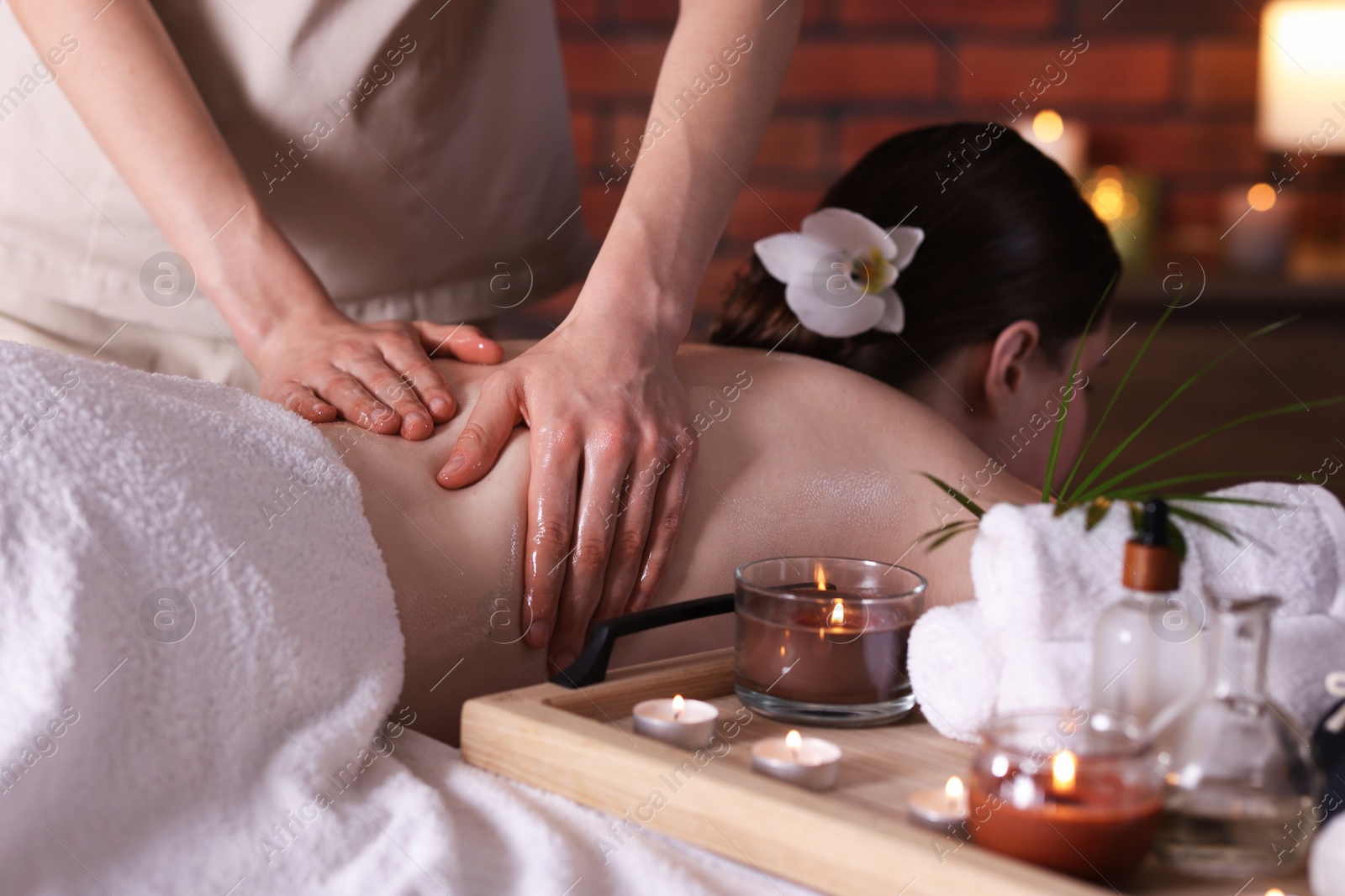 Woman receiving back massage with oil in spa salon Photo of Woman receiving back massage with oil in spa salon