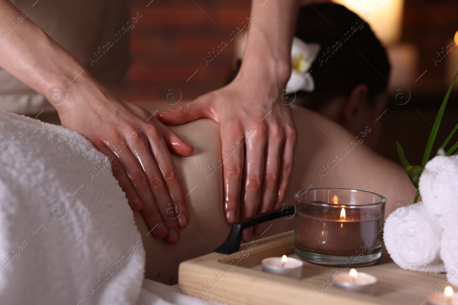 Woman receiving back massage with oil in spa salon Photo of Woman receiving back massage with oil in spa salon