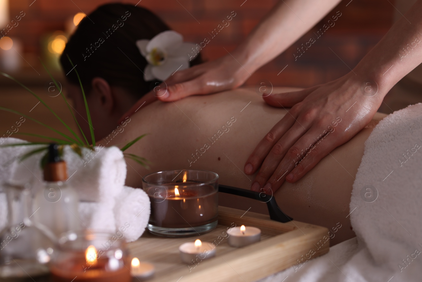 Woman receiving back massage with oil in spa salon Photo of Woman receiving back massage with oil in spa salon