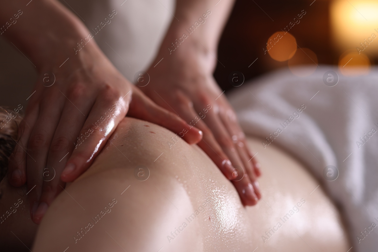 Woman receiving back massage with oil in spa salon, closeup Photo of Woman receiving back massage with oil in spa salon, closeup