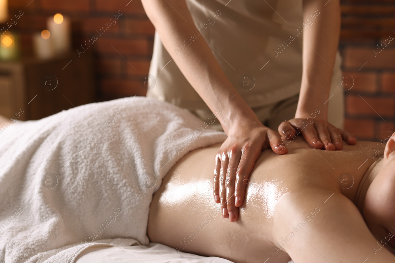 Woman receiving back massage with oil in spa salon, closeup Photo of Woman receiving back massage with oil in spa salon, closeup