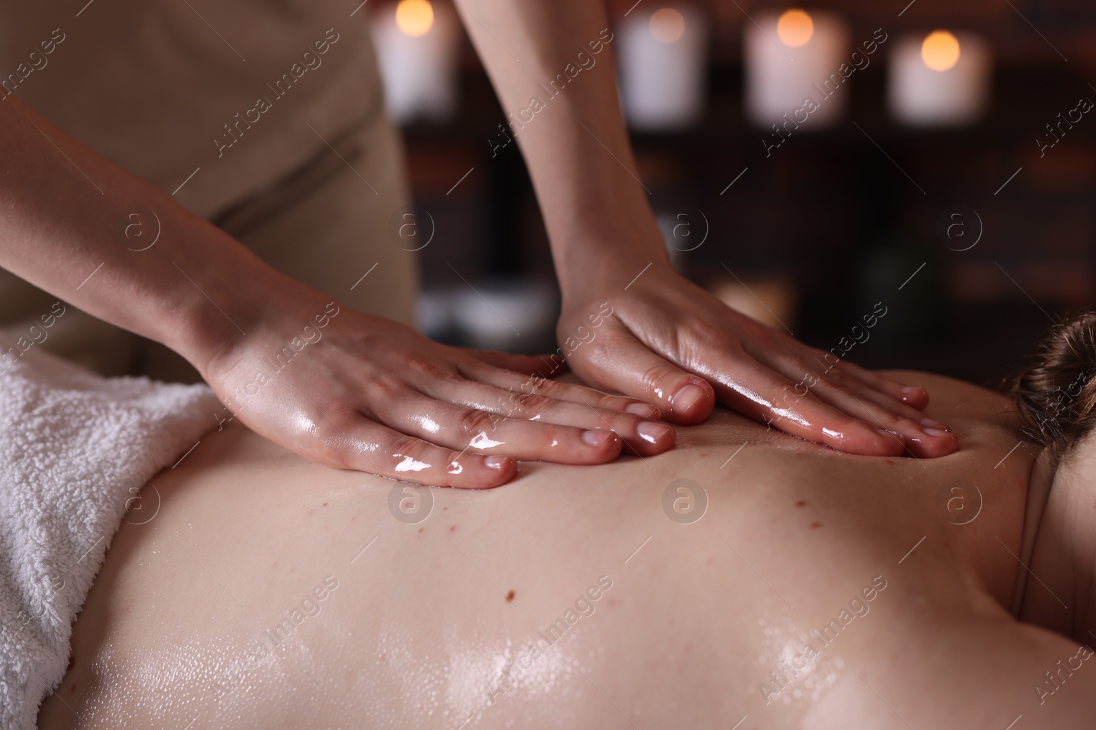 Woman receiving back massage with oil in spa salon, closeup Photo of Woman receiving back massage with oil in spa salon, closeup