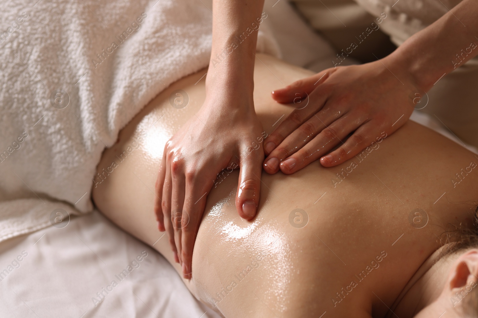 Woman receiving back massage with oil in spa salon, closeup Photo of Woman receiving back massage with oil in spa salon, closeup