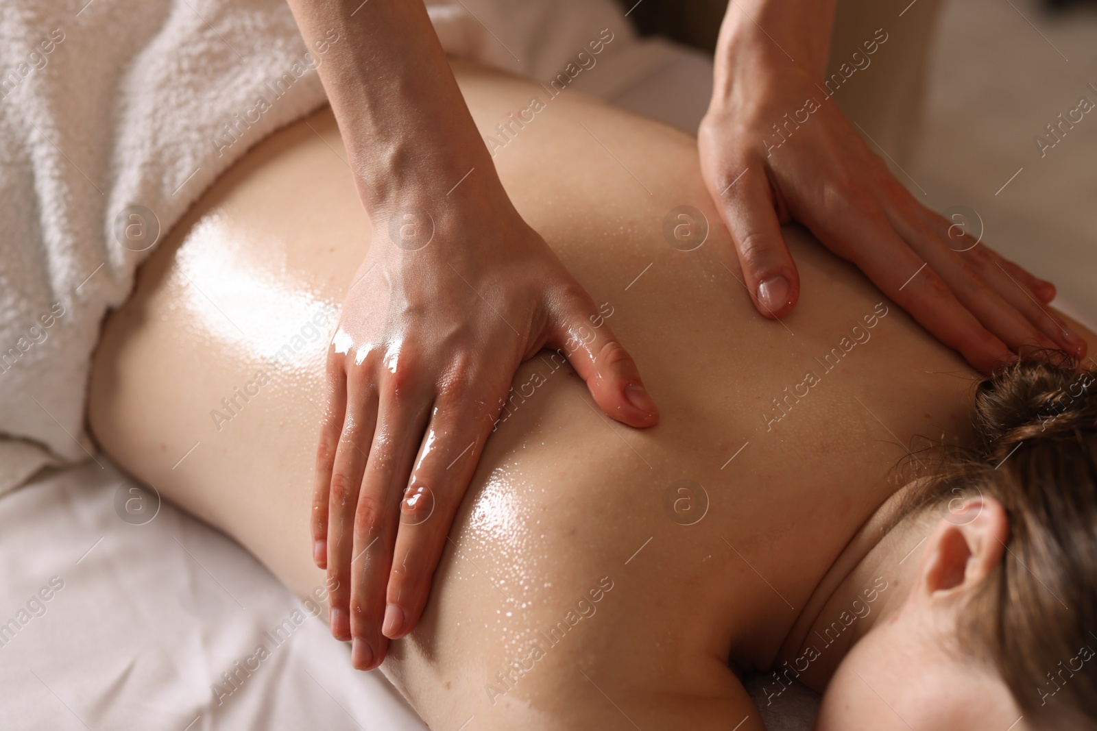 Woman receiving back massage with oil in spa salon, closeup Photo of Woman receiving back massage with oil in spa salon, closeup