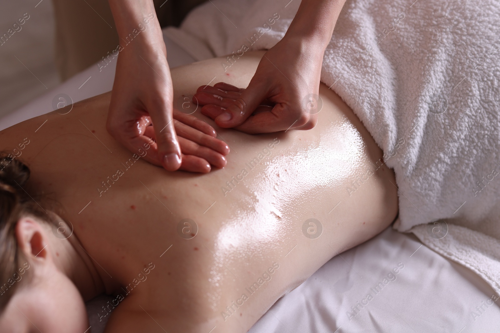 Woman receiving back massage with oil in spa salon, closeup Photo of Woman receiving back massage with oil in spa salon, closeup
