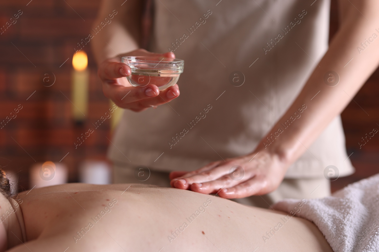 Woman receiving back massage with oil in spa salon, closeup Photo of Woman receiving back massage with oil in spa salon, closeup