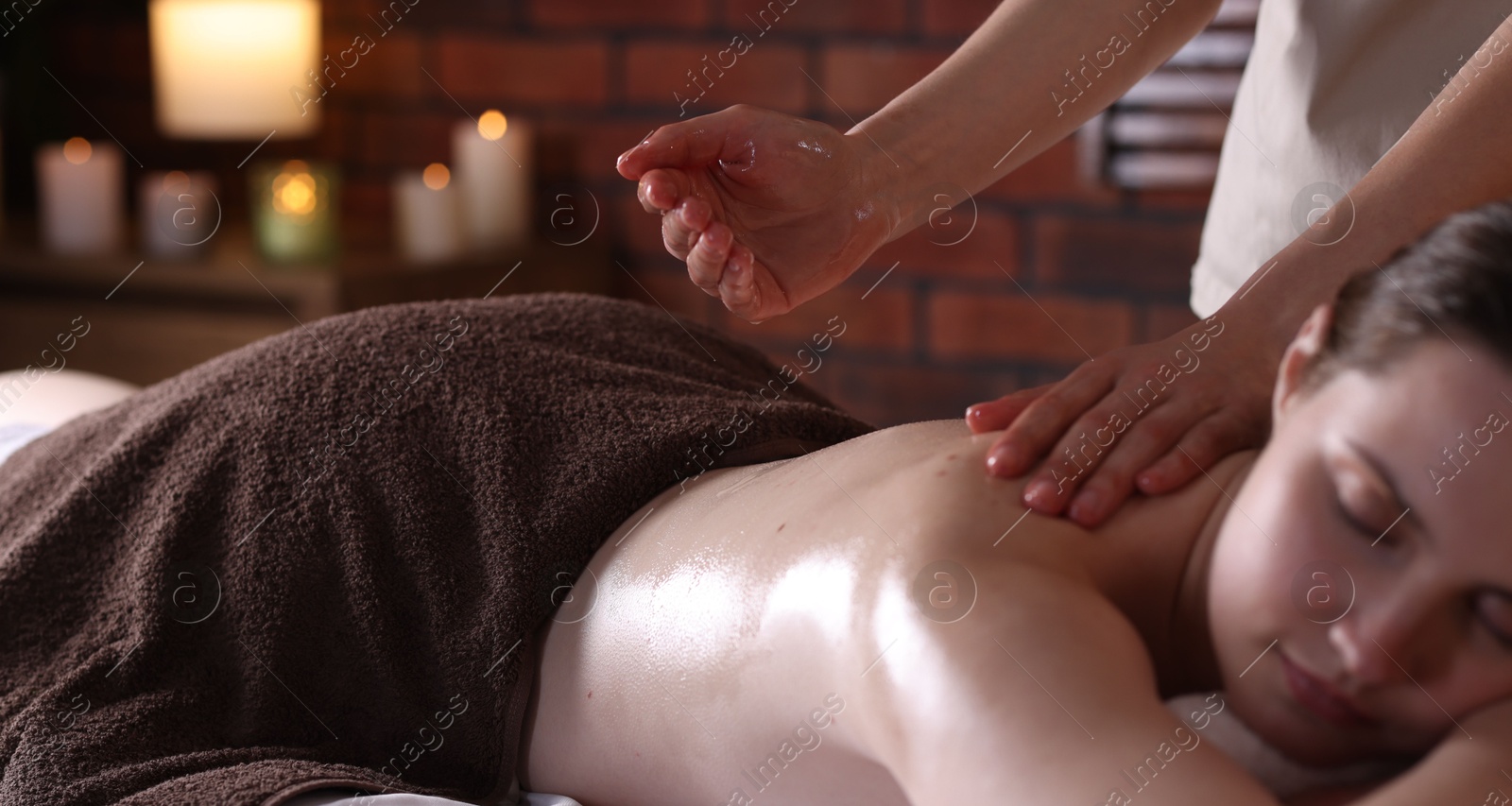 Woman receiving back massage with oil in spa salon Photo of Woman receiving back massage with oil in spa salon