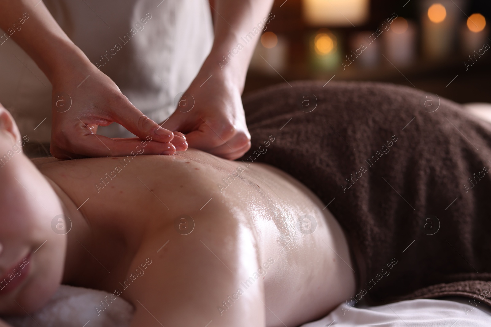 Woman receiving back massage with oil in spa salon, closeup Photo of Woman receiving back massage with oil in spa salon, closeup